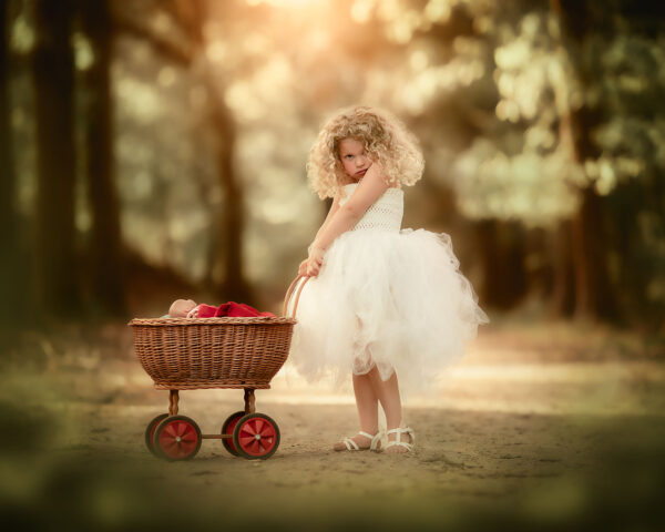 Canon EOS R fine art child portrait of a blonde little curly girl with a doll and her stroller by Dutch photographer Willie Kers